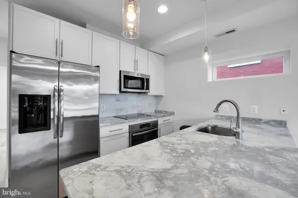 a kitchen with a refrigerator and a sink
