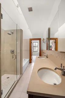 a spacious bathroom with a granite countertop sink a mirror and shower