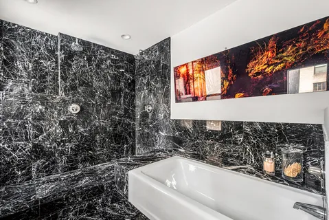 a bathroom with a bathtub and shower