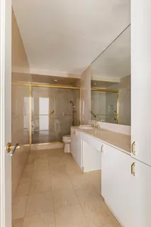 a large white tub sitting in a bathroom with mirror