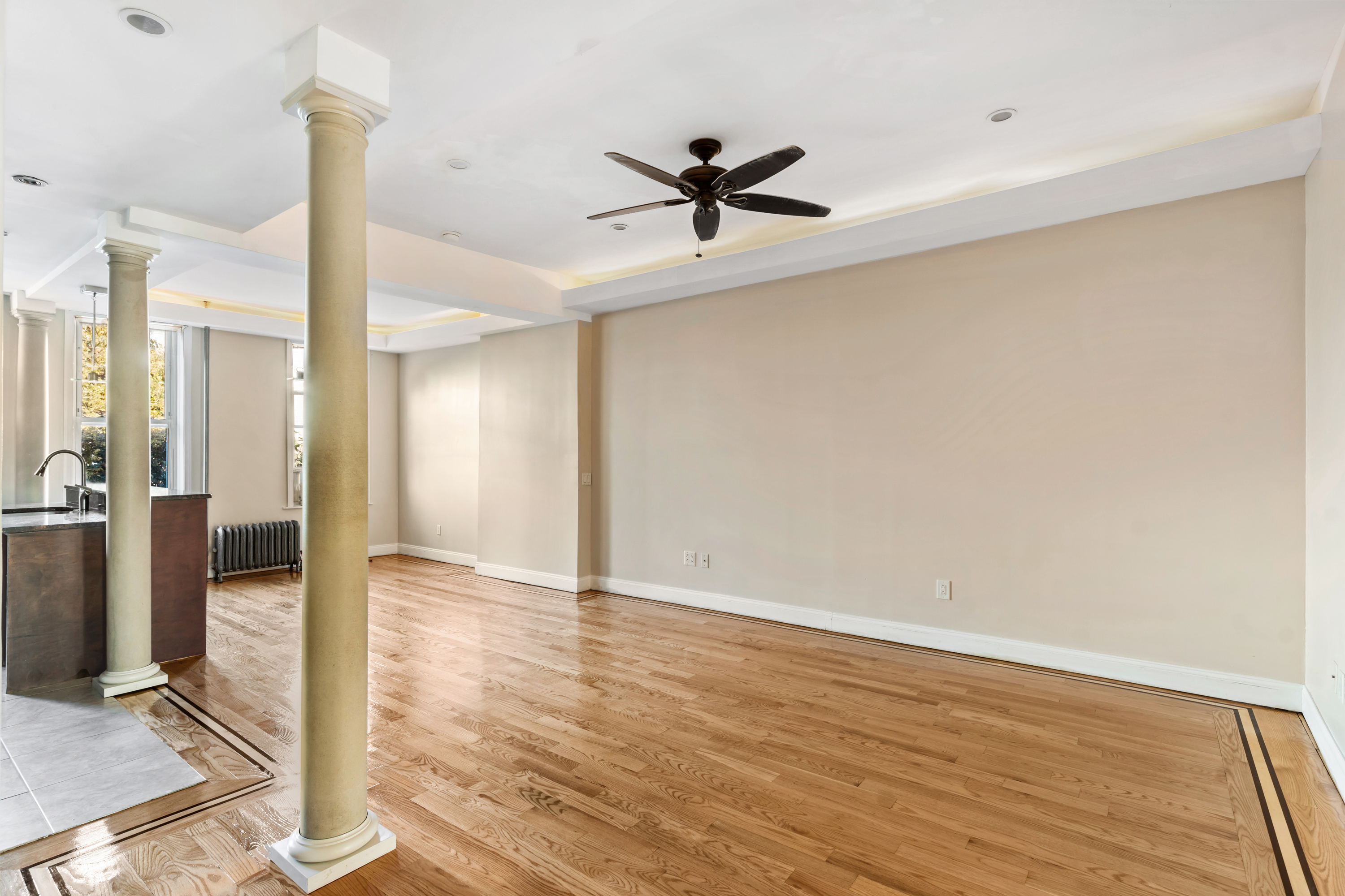 60-13 Menahan Street, Unit 1 Queens, NY 11385 - Photo 4 of 19 a view of empty room with wooden floor and fan