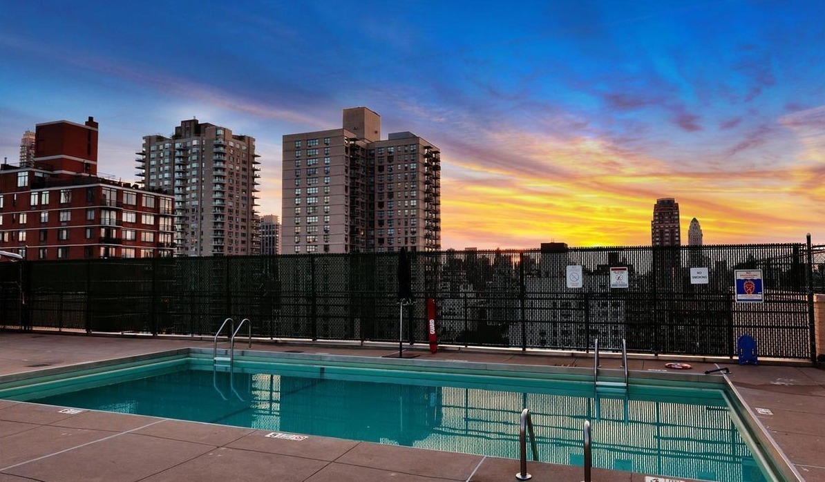 370 East 76th Street, Unit C1208 Manhattan, NY 10021 - Photo 5 of 6 a view of outdoor space with swimming pool and patio