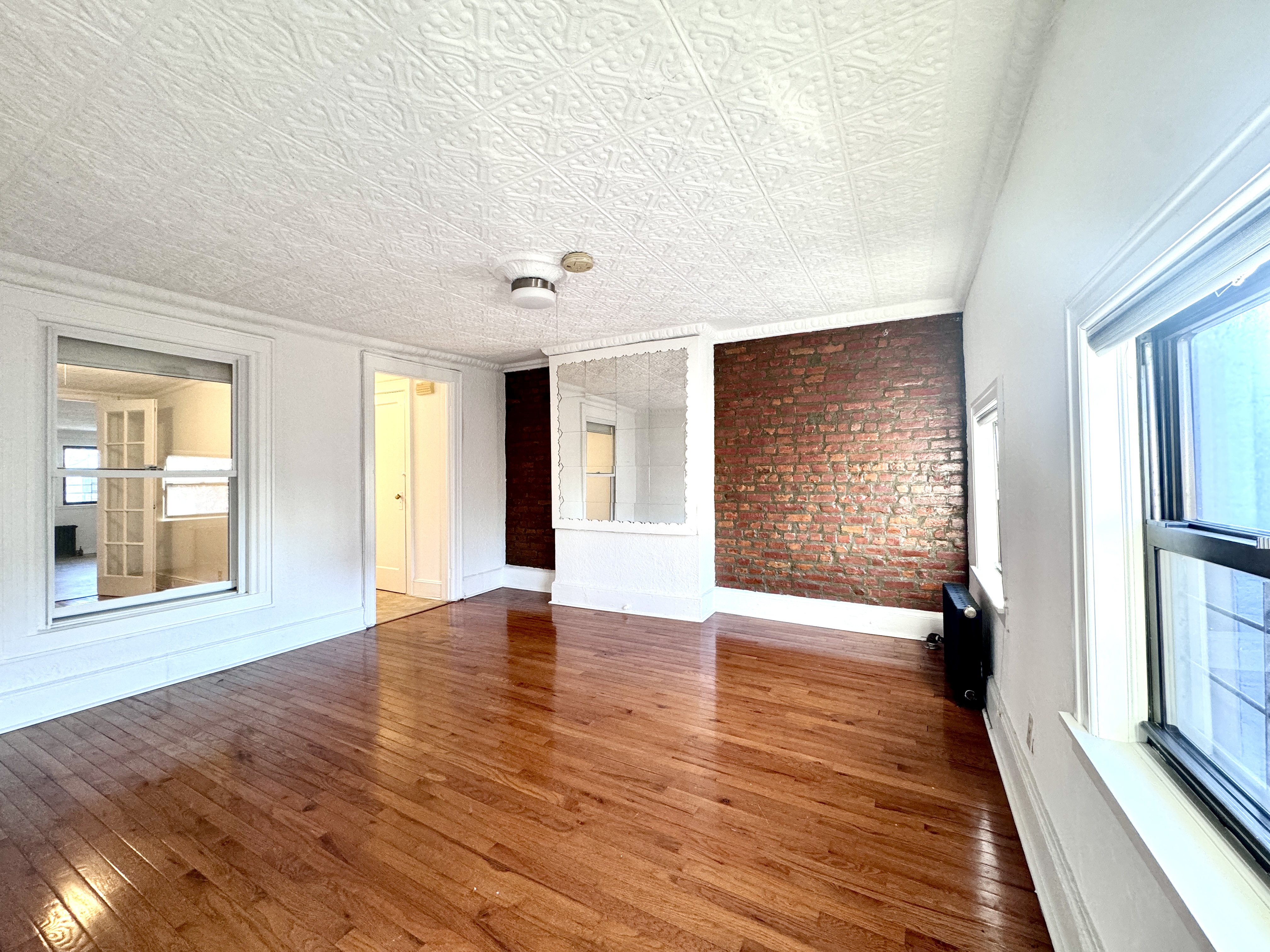 195 Court Street, Unit 4 Brooklyn, NY 11201 - Photo 1 of 11 a view of an empty room with wooden floor and a window