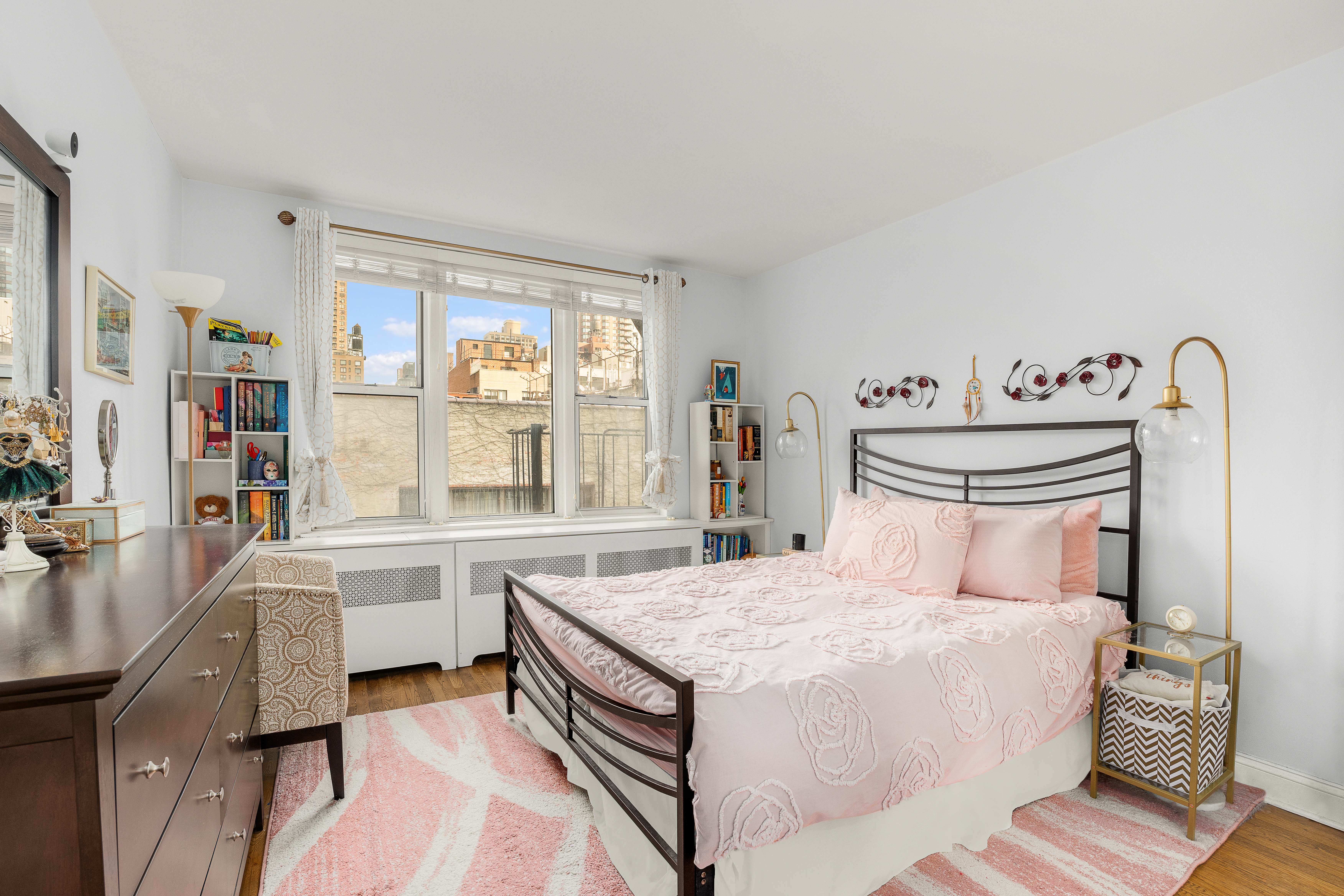311 East 75th Street, Unit 4K Manhattan, NY 10021 - Photo 6 of 8 a bedroom with a large bed and a large window