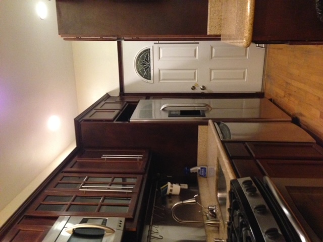 250 57th Street Brooklyn, NY 11220 - Photo 6 of 15 a kitchen with stainless steel appliances granite countertop a refrigerator and a stove top oven