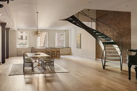 a view of a livingroom with furniture and stairs