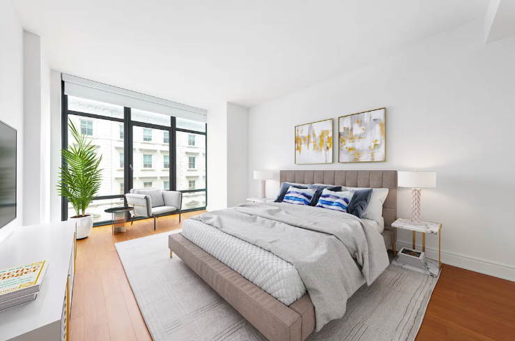 57 Reade Street, Unit 5B Manhattan, NY 10007 - Photo 3 of 5 a bedroom with a large bed and a large window