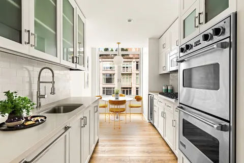 a kitchen with stainless steel appliances kitchen island granite countertop a sink and cabinets