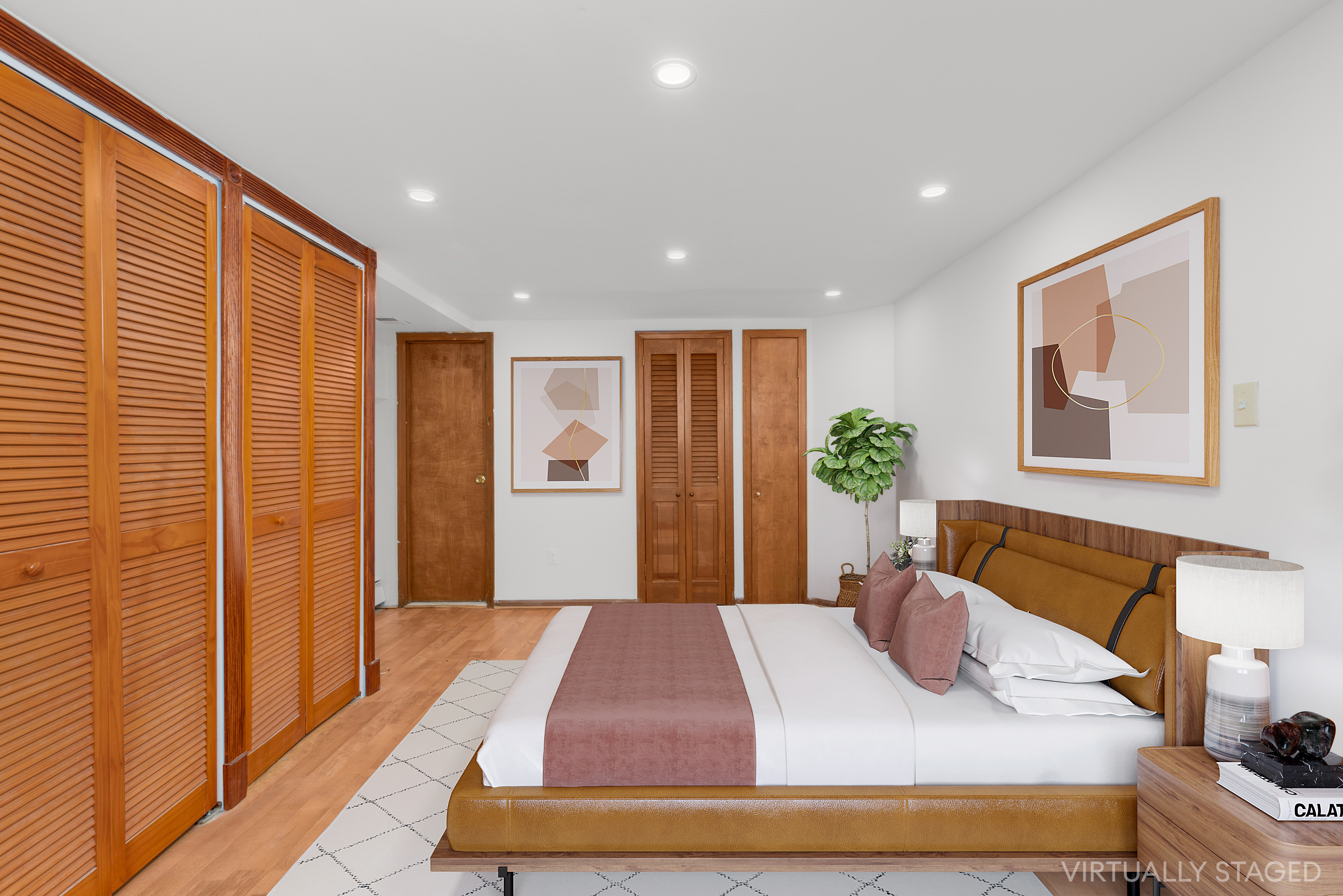 252 West 102nd Street, Unit 1 Manhattan, NY 10025 - Photo 7 of 12 a bedroom with a large bed and a potted plant