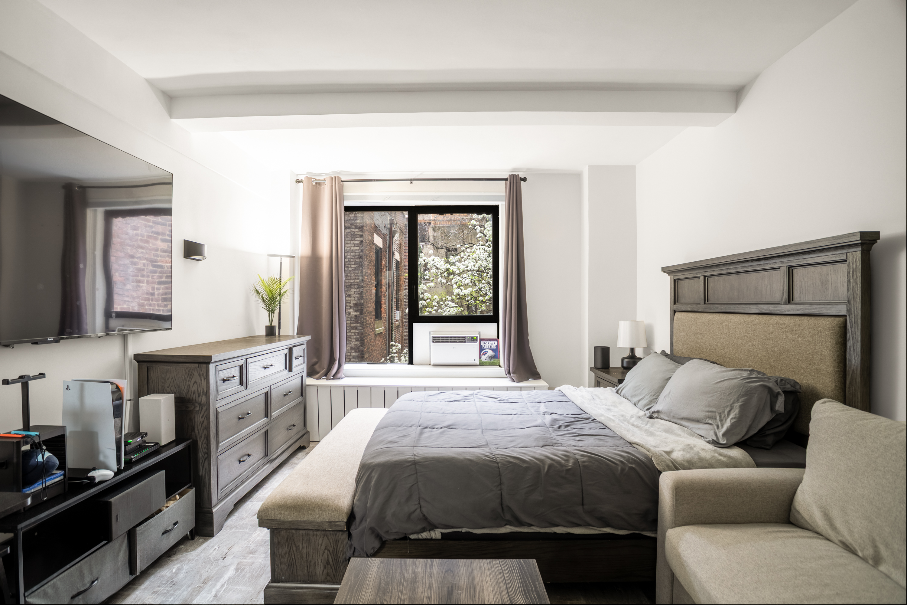 235 West 102nd Street, Unit 3T Manhattan, NY 10025 - Photo 2 of 10 a bedroom with a large bed and a window