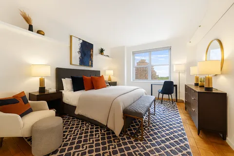 a bedroom with bed and wooden floor