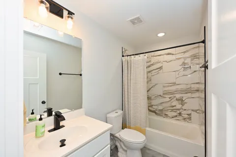 a bathroom with a sink toilet and shower