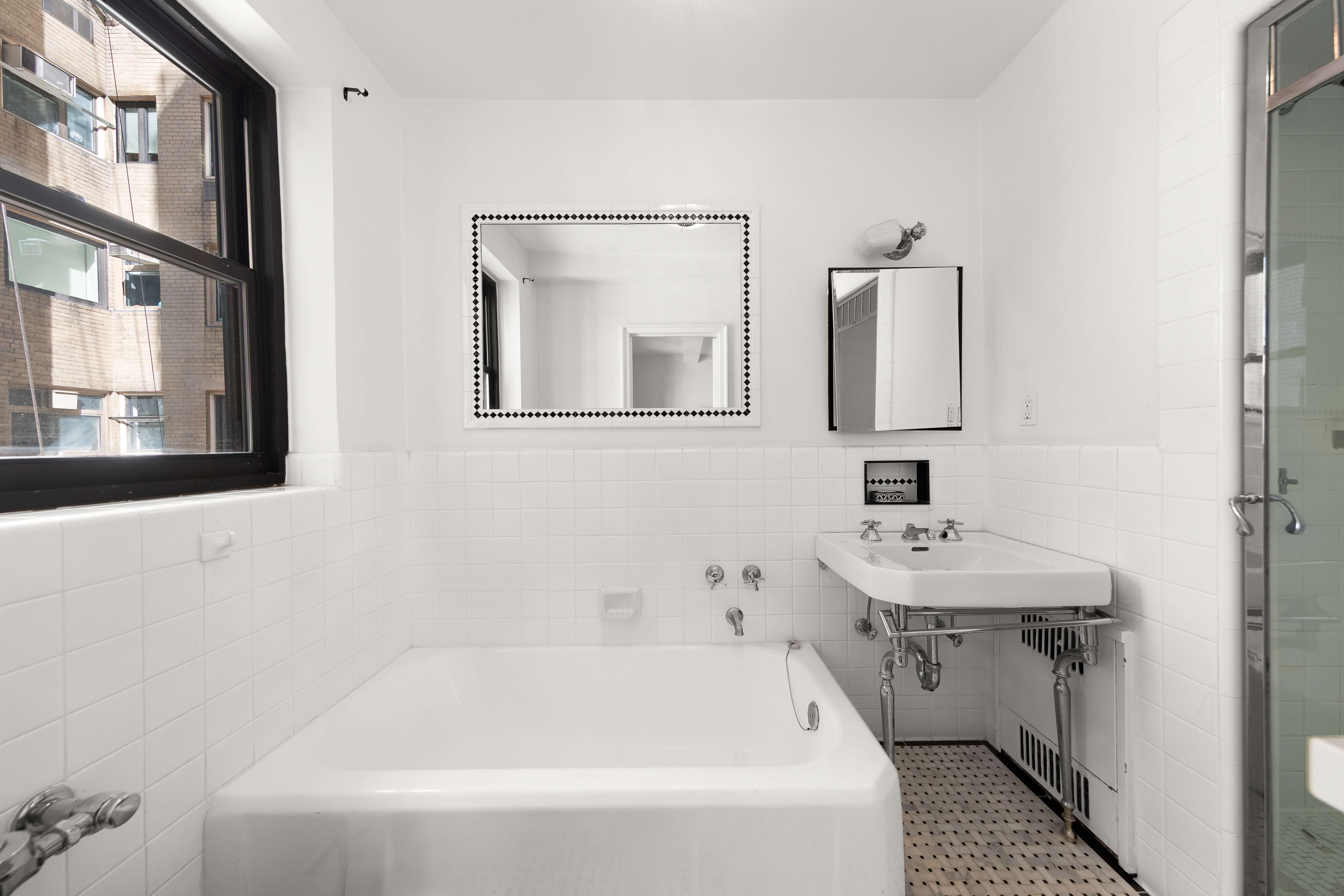 875 5th Avenue, Unit 9GH Manhattan, NY 10065 - Photo 9 of 13 a bathroom with a sink and a bathtub