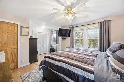 a bedroom with a bed and a chandelier