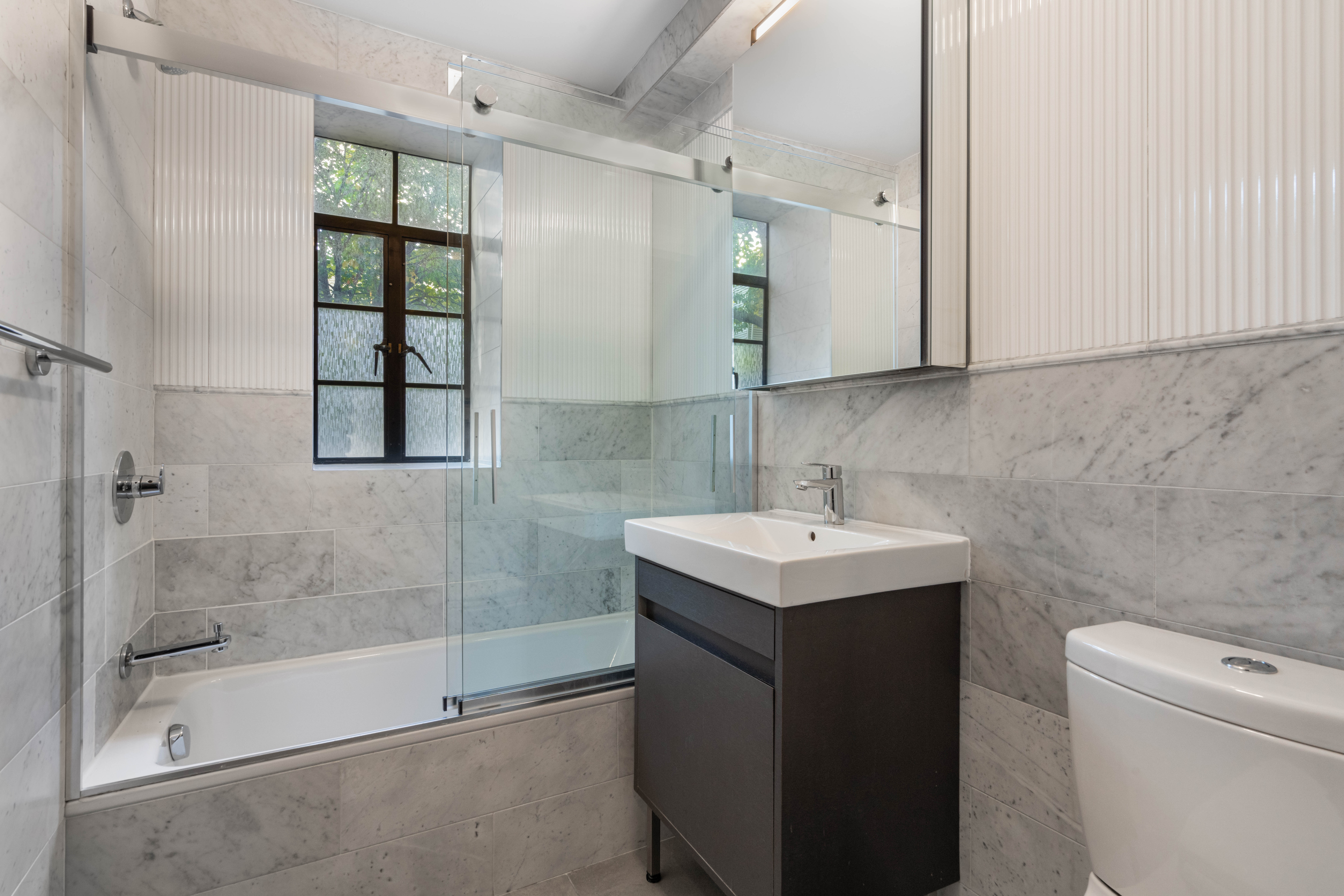 25 Monroe Place, Unit 6E Brooklyn, NY 11201 - Photo 3 of 10 a bathroom with a sink toilet and shower