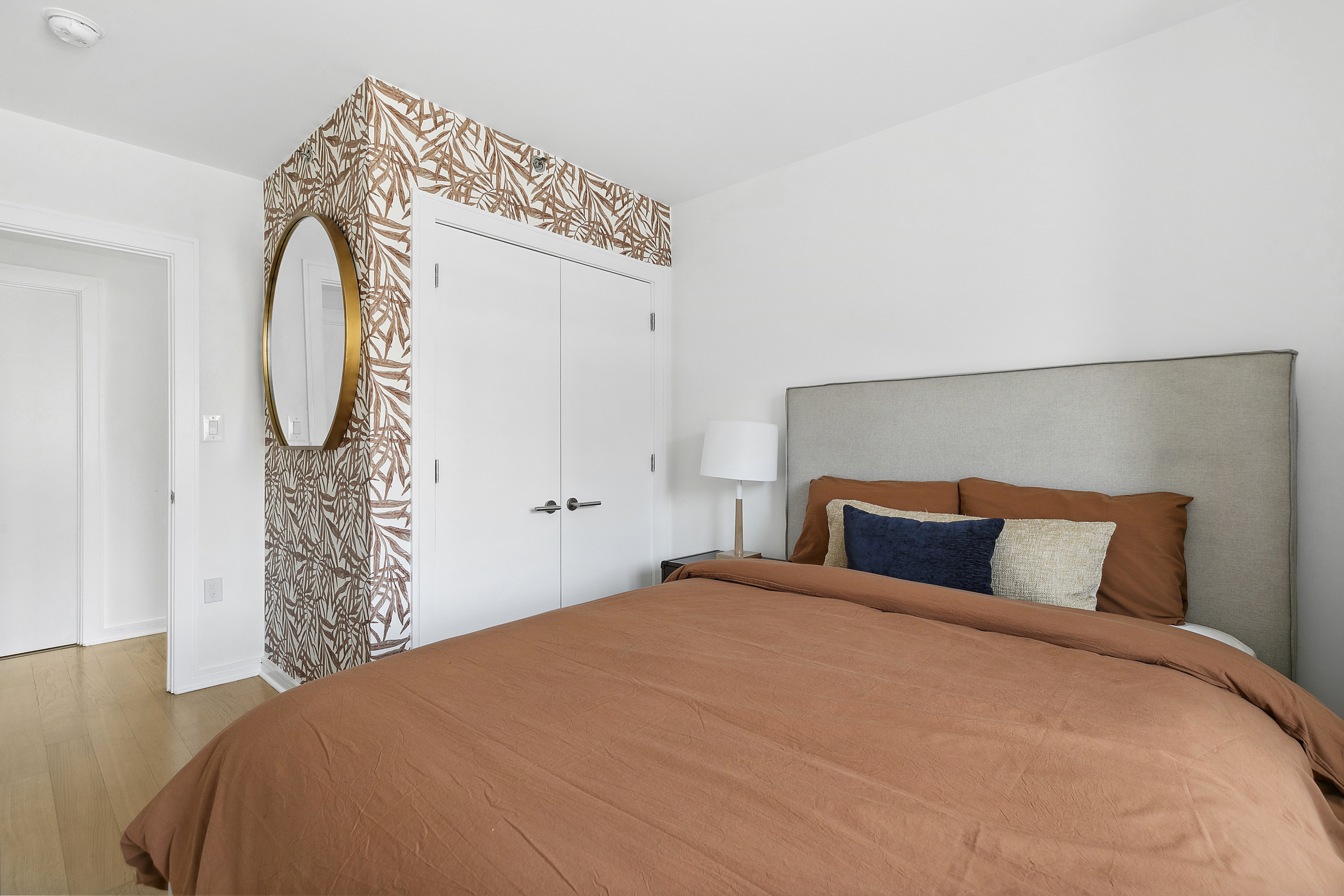 171 West 131st Street, Unit 407 Manhattan, NY 10027 - Photo 10 of 18 a bedroom with a bed and a mirror