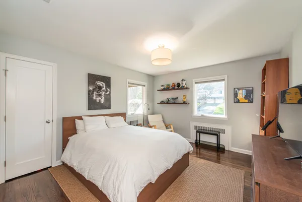 a bedroom with a bed and a desk