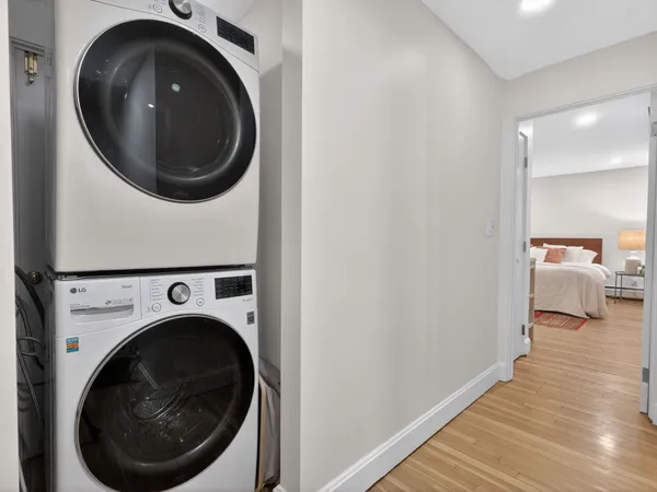 a view of a hallway with washer and dryer