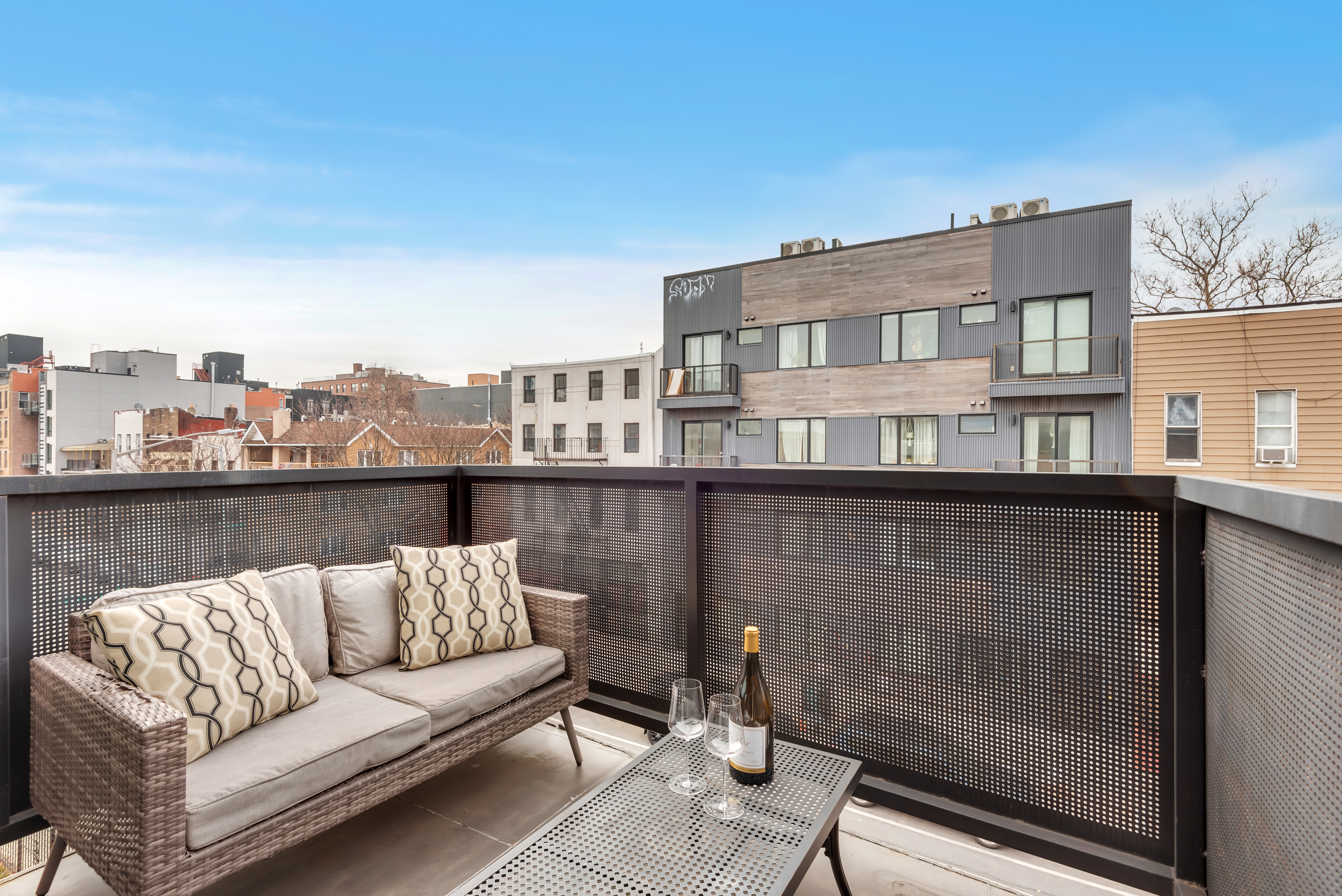 267 Evergreen Avenue, Unit 3A Brooklyn, NY 11221 - Photo 6 of 16 a balcony with a couch and a potted plant
