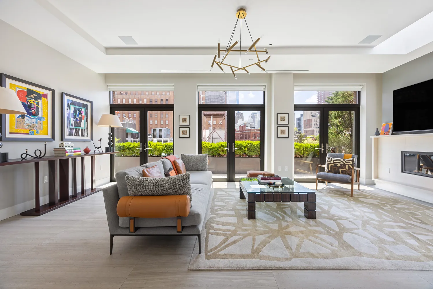 a living room with patio furniture and a flat screen tv