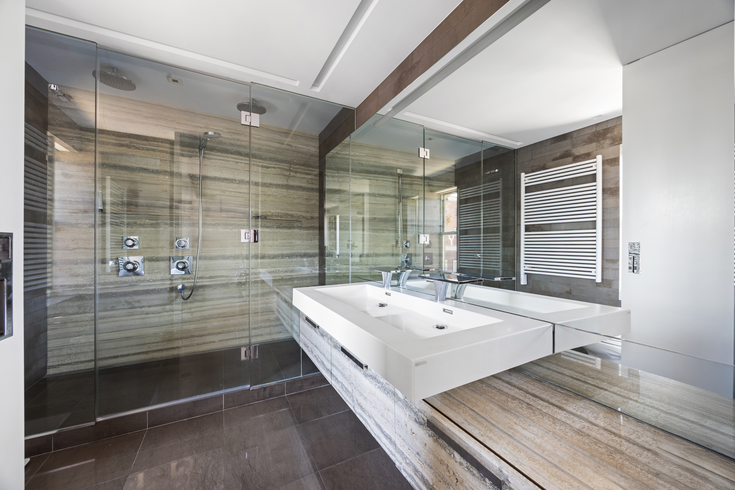 24 5th Avenue, Unit PH1701 Manhattan, NY 10011 - Photo 15 of 24 a en suite bathroom with sink and mirror