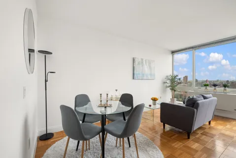 a view of a dining room with furniture and window