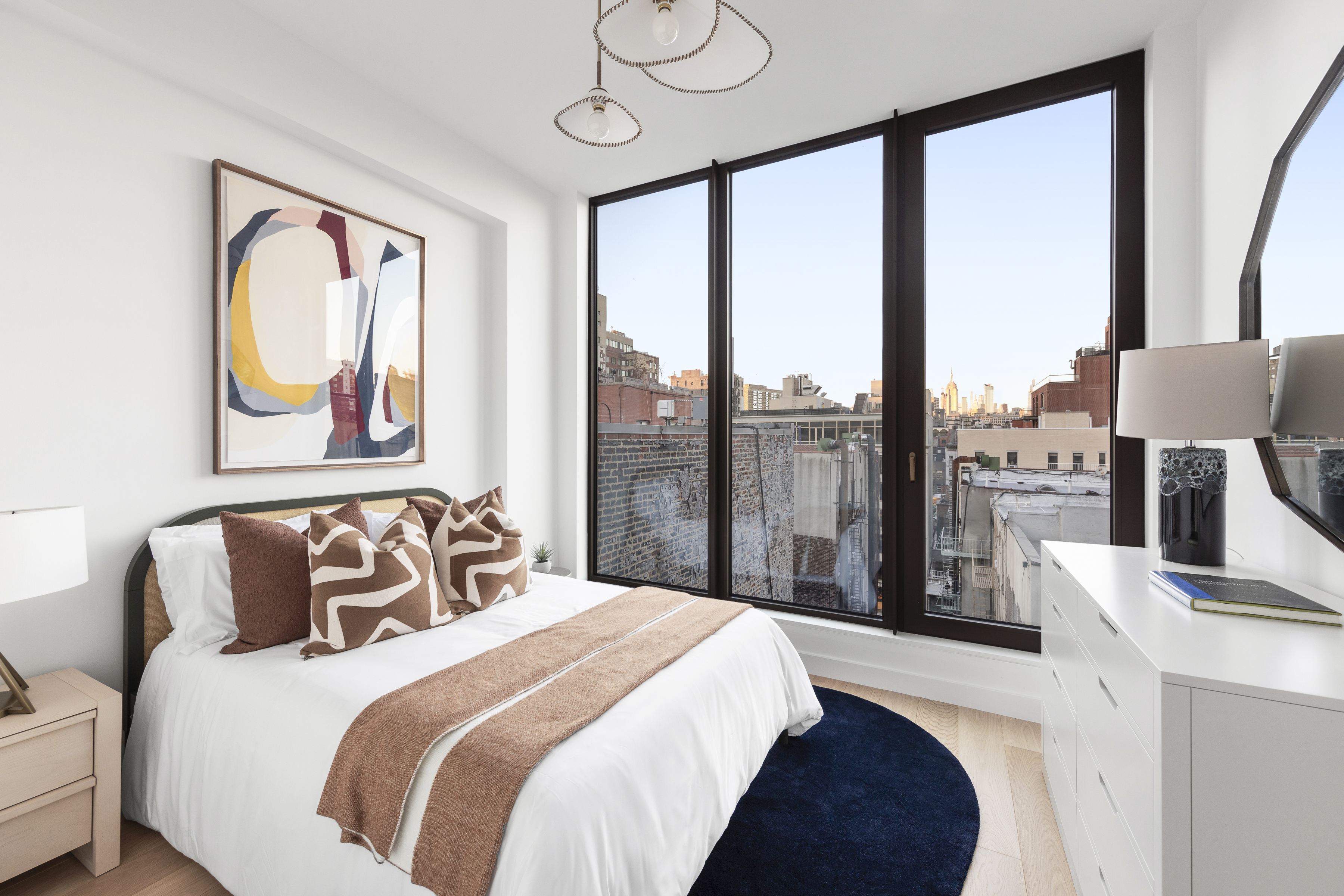 378 Broome Street, Unit PH Manhattan, NY 10013 - Photo 18 of 25 a bedroom with furniture and a large window