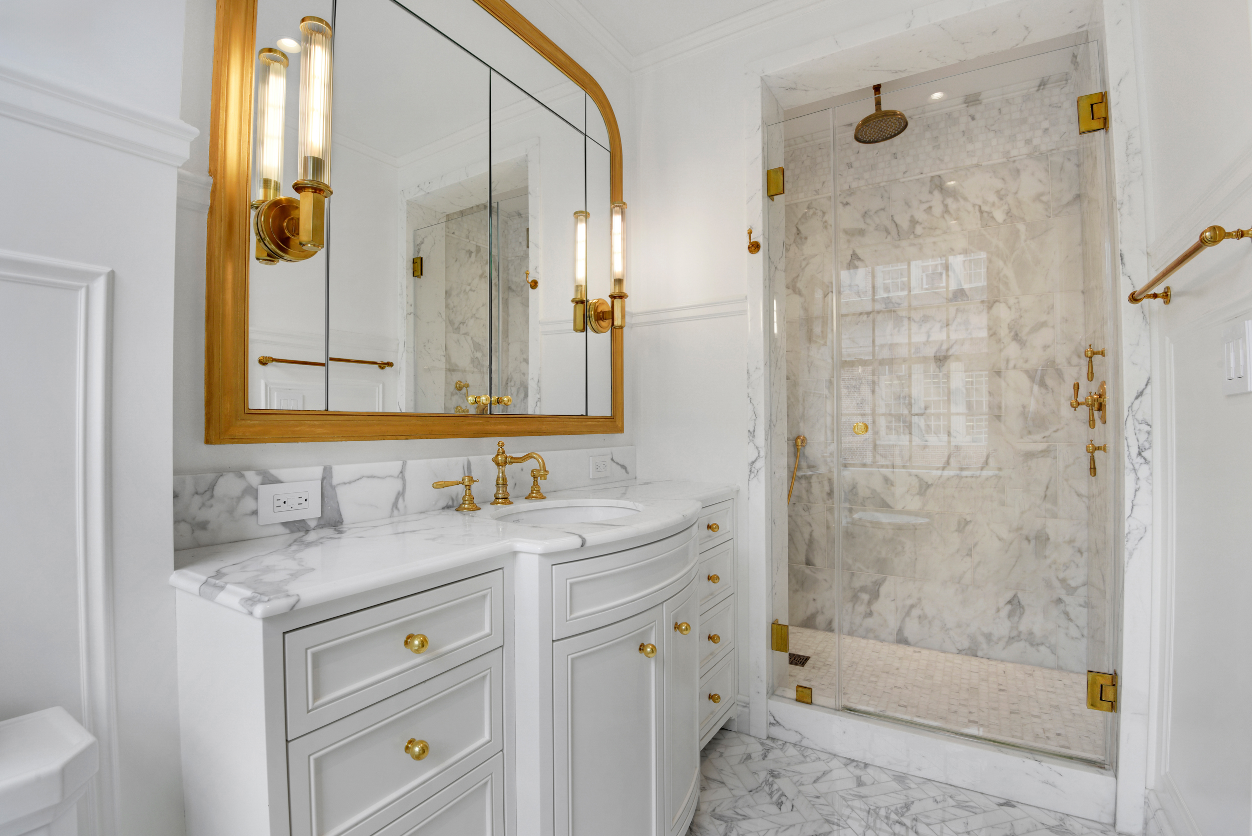 333 East 68th Street, Unit 6C Manhattan, NY 10065 - Photo 9 of 13 a bathroom with a granite countertop sink a mirror a shower and a bathtub