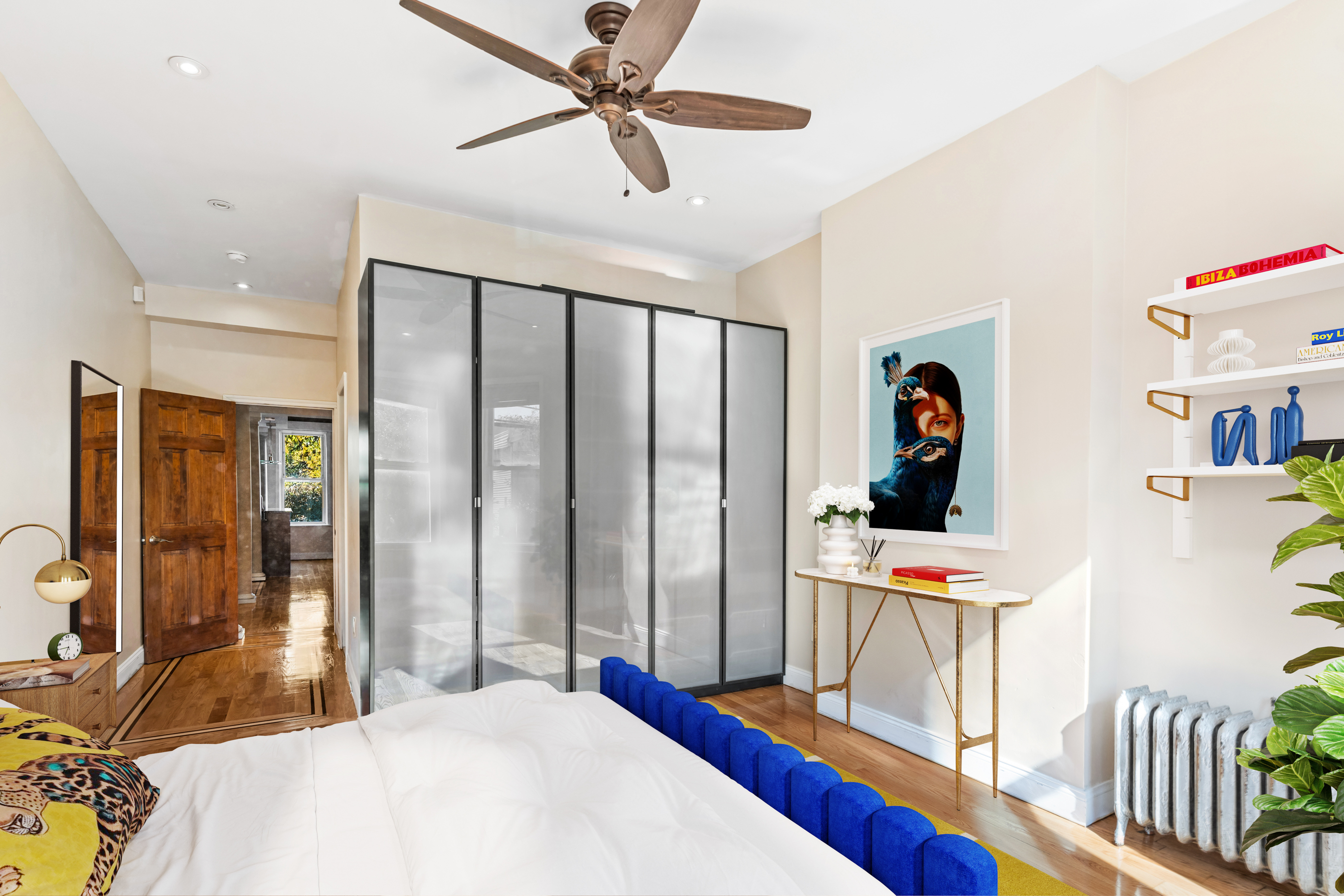 60-13 Menahan Street, Unit 1 Queens, NY 11385 - Photo 12 of 19 a bedroom with a bed and a chandelier