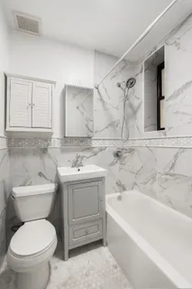 a bathroom with a toilet sink and bathtub