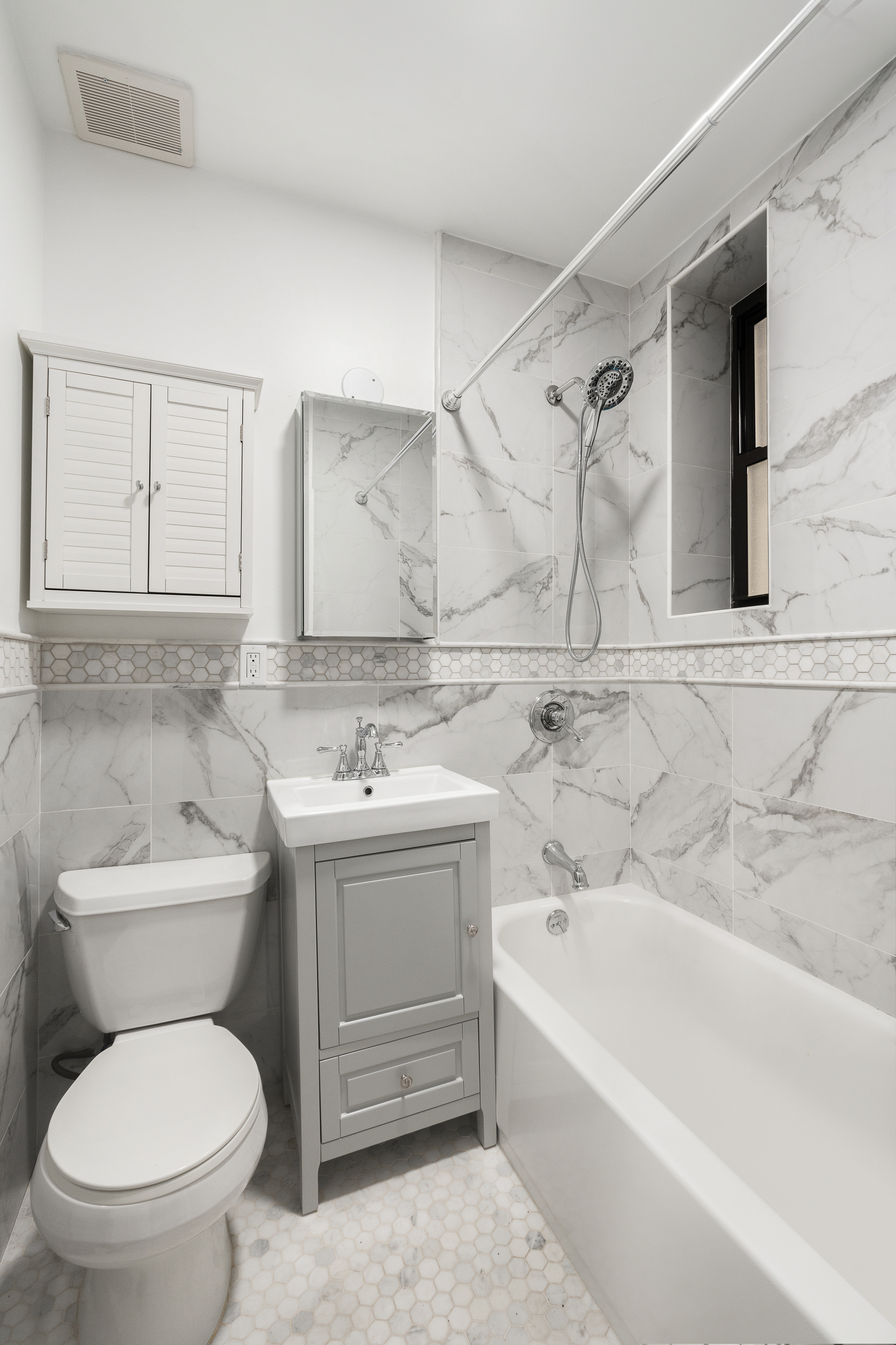 227 East 87th Street, Unit C Manhattan, NY 10128 - Photo 5 of 8 a bathroom with a toilet sink and bathtub