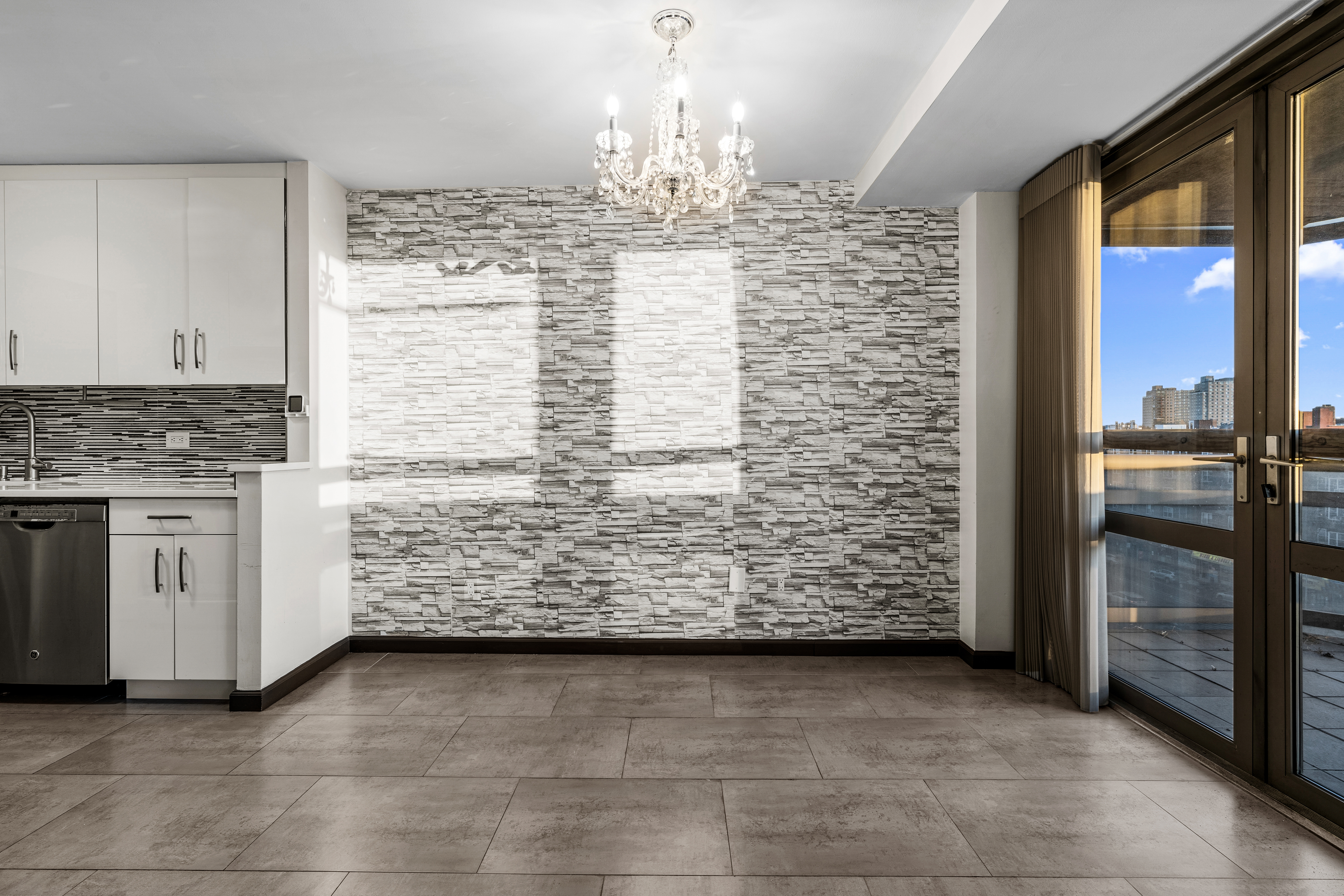 112-01 Queens Boulevard, Unit 7E Queens, NY 11375 - Photo 9 of 27 a view of kitchen with granite countertop cabinets and chandelier