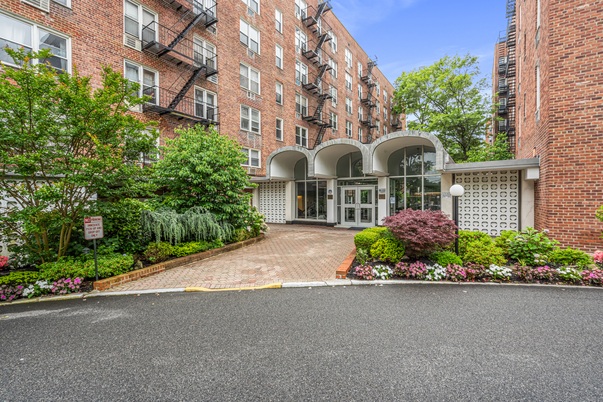 54-44 Little Neck Parkway, Unit 5G Queens, NY 11362 - Photo 2 of 20 a front view of a house with a garden