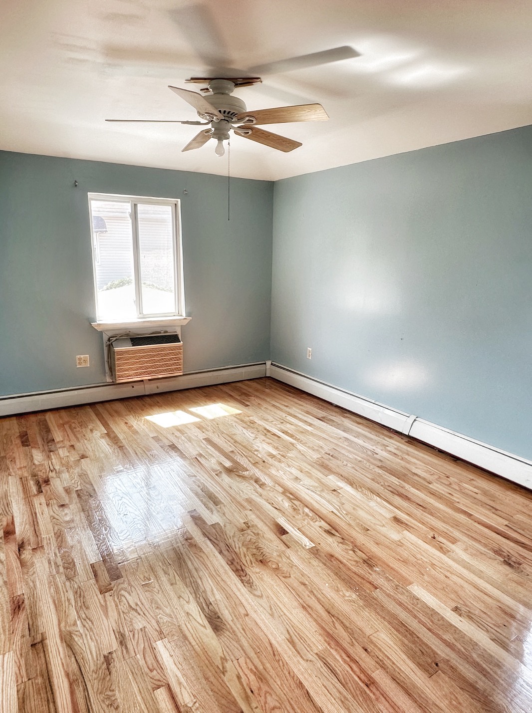 2130 Troy Avenue, Unit 2 Brooklyn, NY 11234 - Photo 4 of 4 an empty room with wooden floor and windows