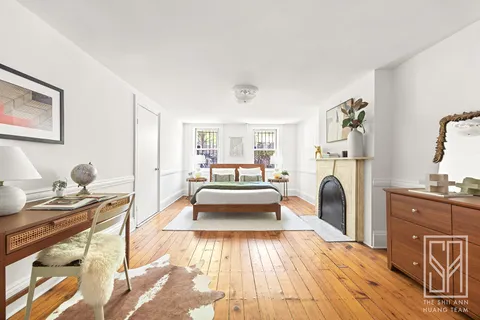 a living room with furniture a fireplace and wood floor