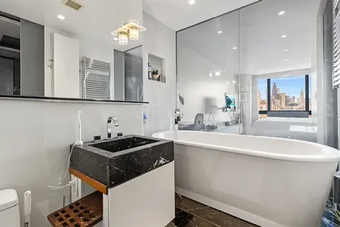 a bathroom with a sink a toilet and a mirror