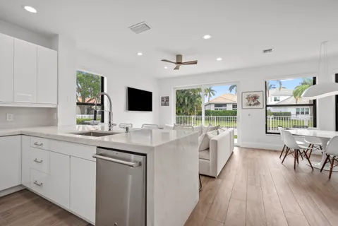 an aerial view of residential houses with outdoor space and lake view