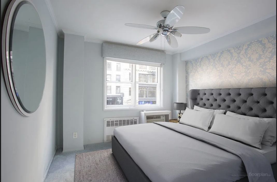170 West 23rd Street, Unit 2F Manhattan, NY 10011 - Photo 3 of 10 a bedroom with a bed and a chandelier