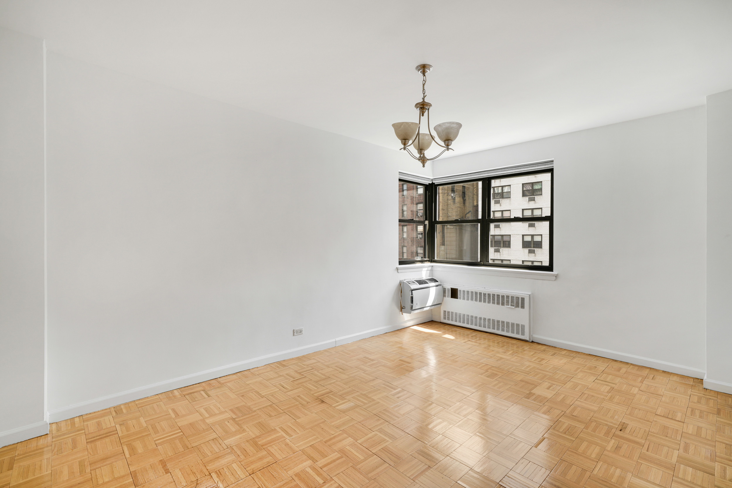 357 East 57th Street, Unit 5D Manhattan, NY 10022 - Photo 12 of 23 an empty room with windows