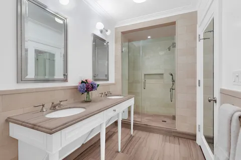 a bathroom with a sink a vanity a mirror and shower