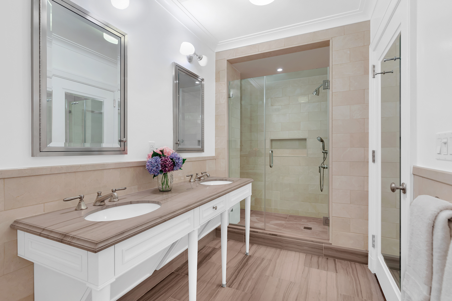 530 Park Avenue, Unit 19G Manhattan, NY 10065 - Photo 6 of 11 a bathroom with a sink a vanity a mirror and shower