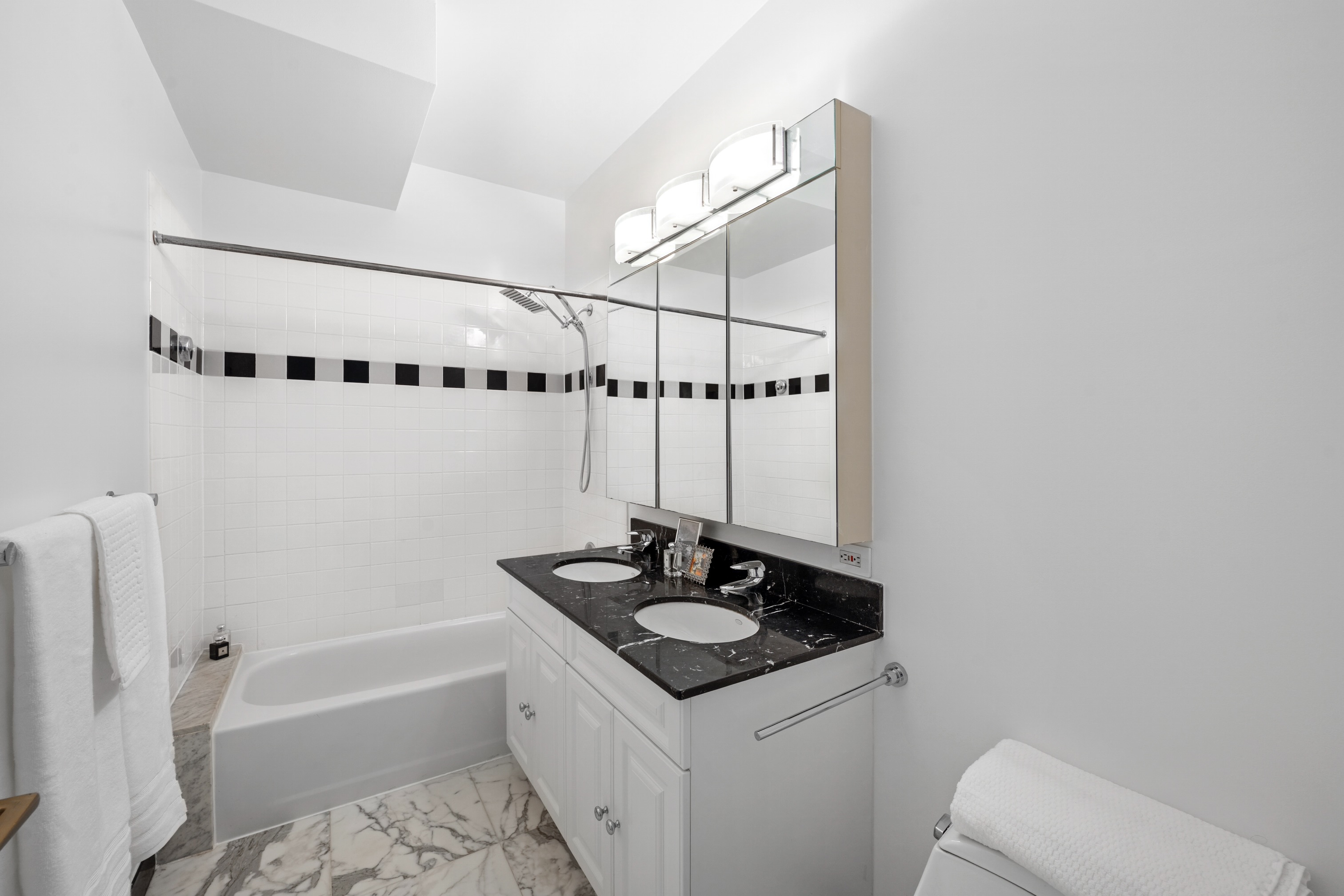 111 West 67th Street, Unit 22B Manhattan, NY 10023 - Photo 7 of 10 a bathroom with a sink a toilet and bathtub