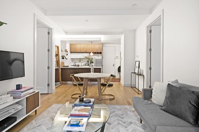 42 Maspeth Avenue, Unit 1D Brooklyn, NY 11211 - Photo 3 of 28 a living room with furniture and a flat screen tv