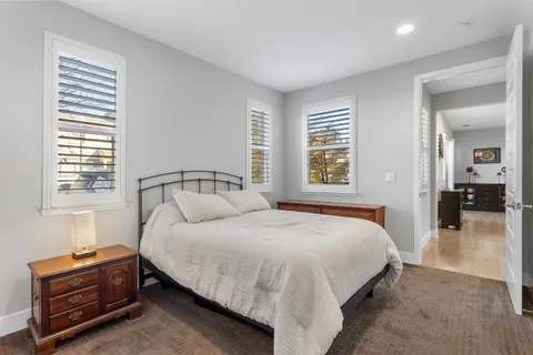 a view of a hallway with workspace and a window