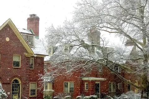a view of a brick building next to a road