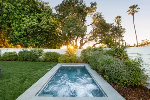 a view of a backyard with large trees