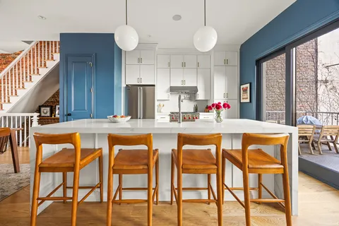 a dining table chairs and chandelier