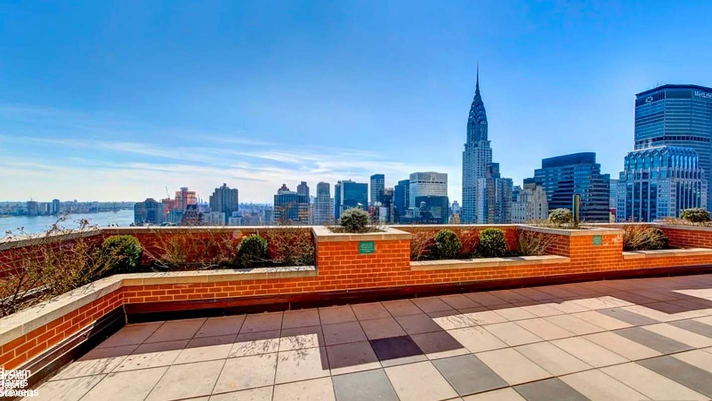 236 East 47th Street, Unit 27DE Manhattan, NY 10017 - Photo 14 of 16 a view of roof deck with couches and city view