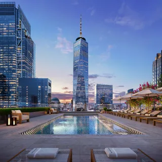 a view of swimming pool with outdoor seating and city view