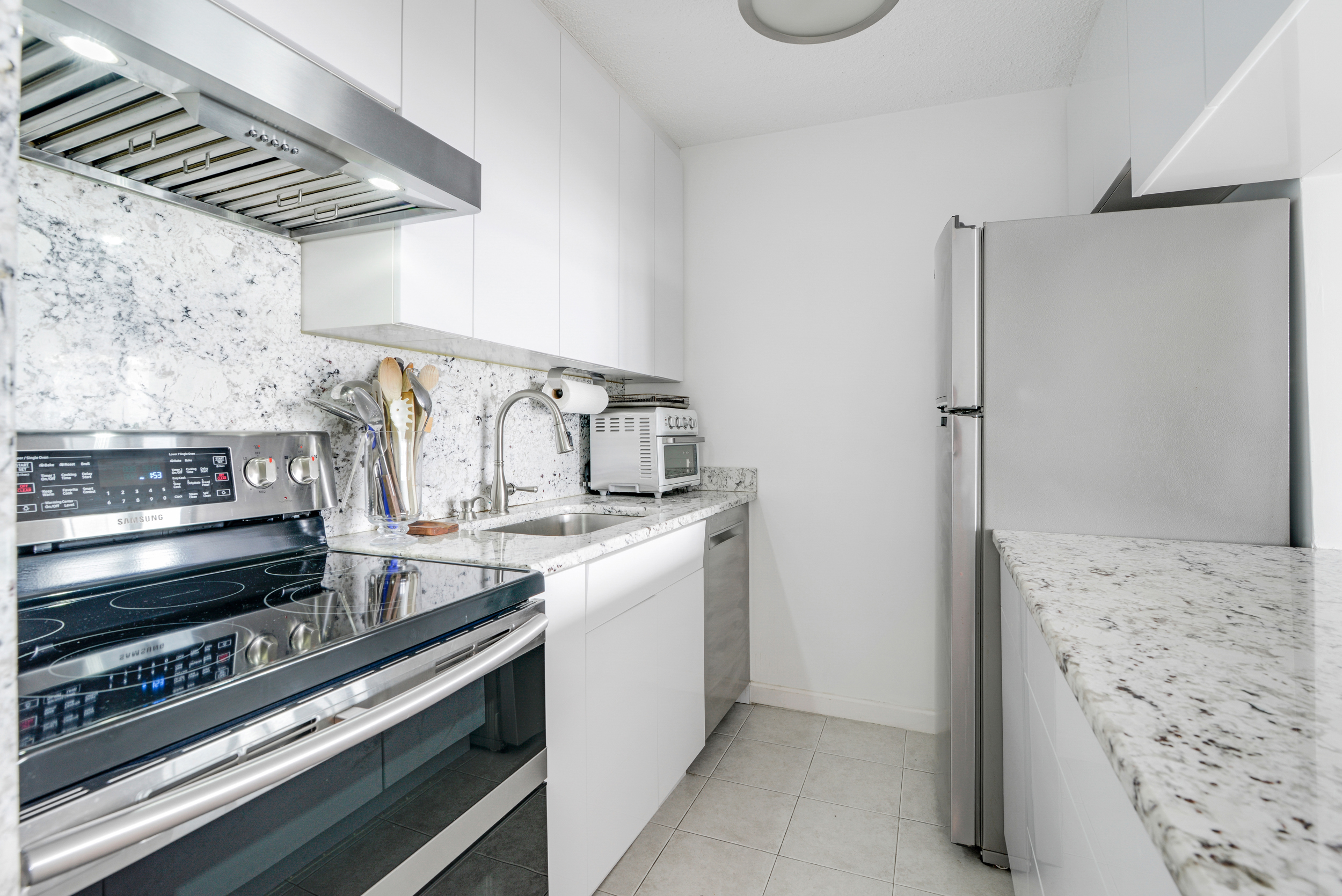 2540 Shore Boulevard, Unit 4S Queens, NY 11102 - Photo 11 of 31 a kitchen with a stove and a refrigerator